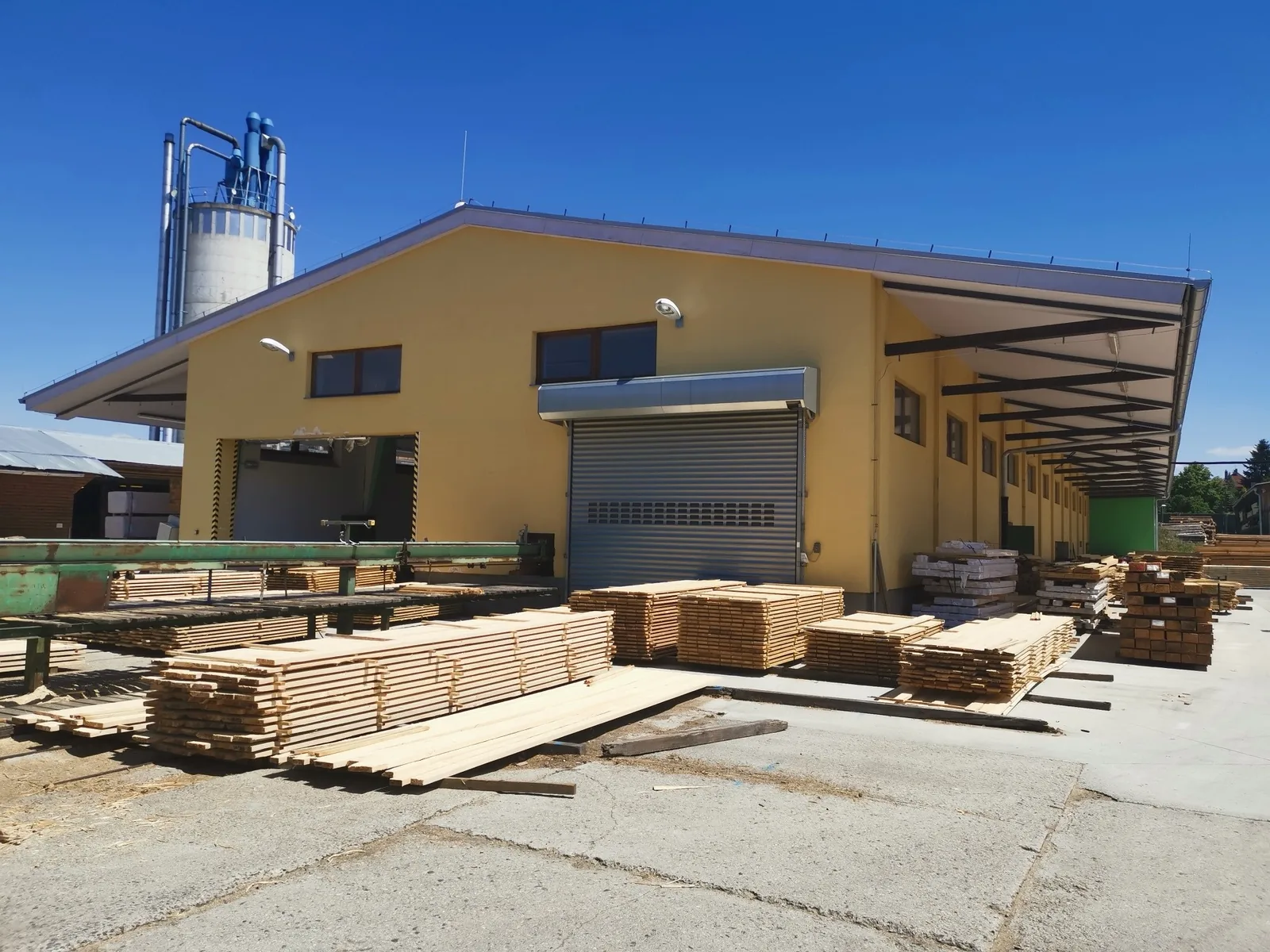 Pila Pasák production building with stacked sawn timber