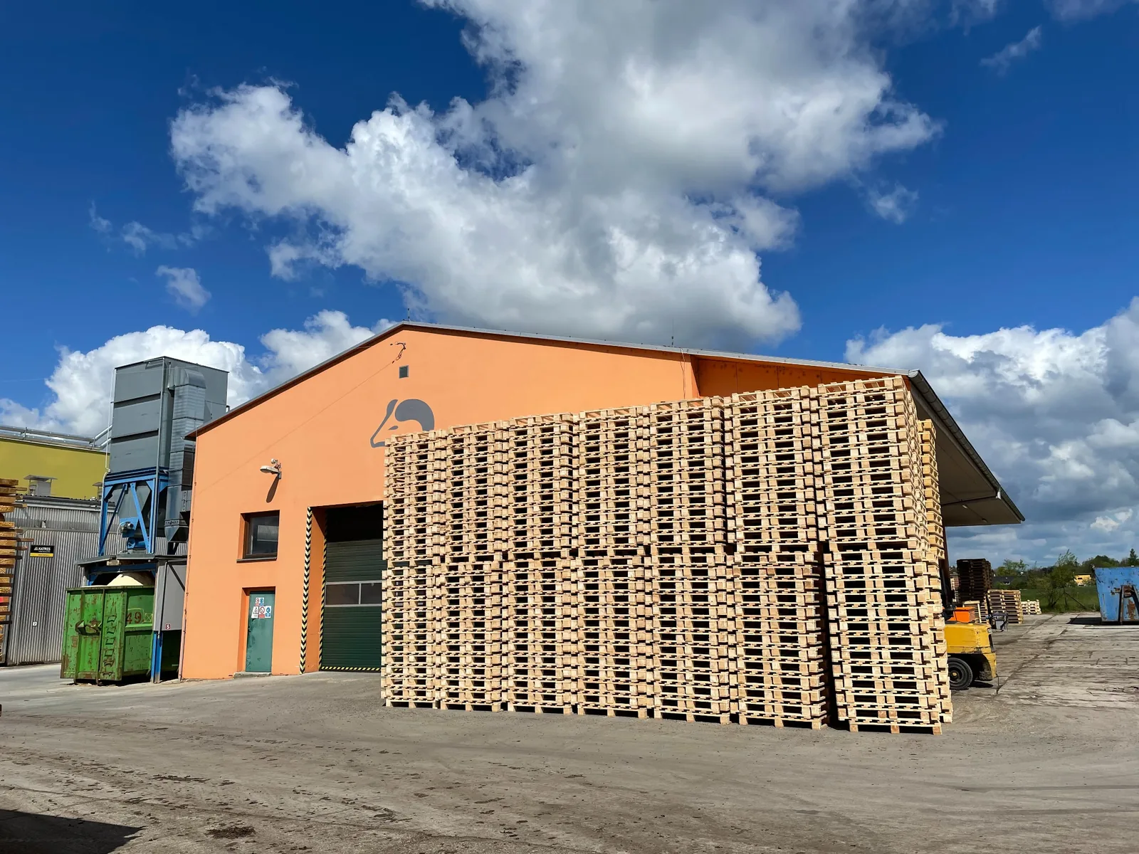Finished wooden pallets stacked outside the production building